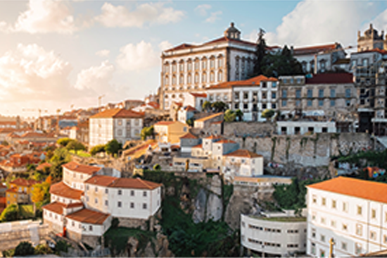 European city on a hill, white buildings with red tile roofs
